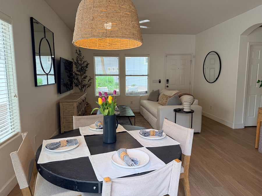 Open-concept dining and living area with warm lighting and a welcoming, home-like atmosphere.
