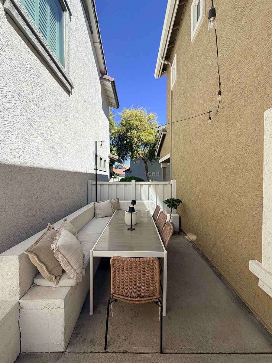 Charming outdoor dining space with string lights for casual meals or unwinding outside.