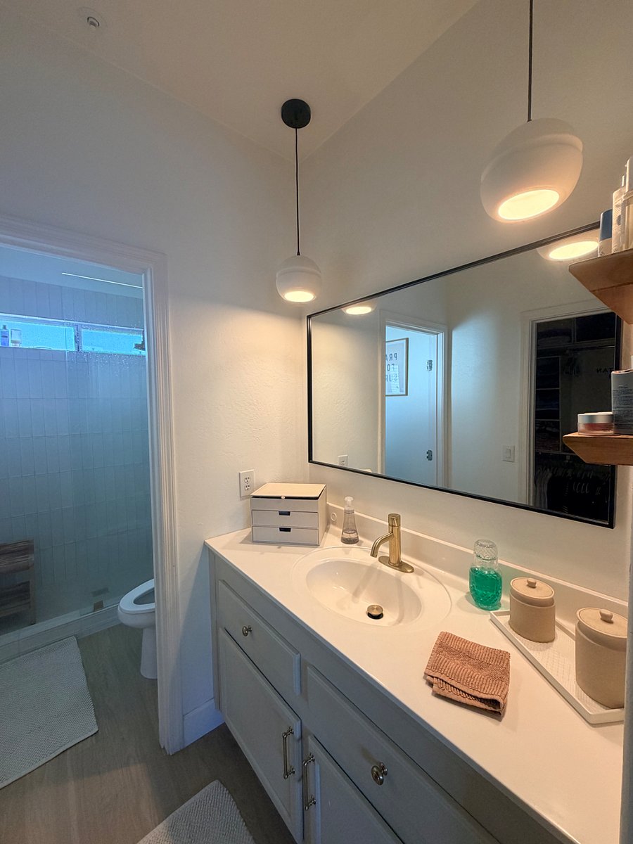 En-suite bath with rain shower.