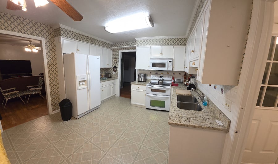 Kitchen view of appliances and cupboards