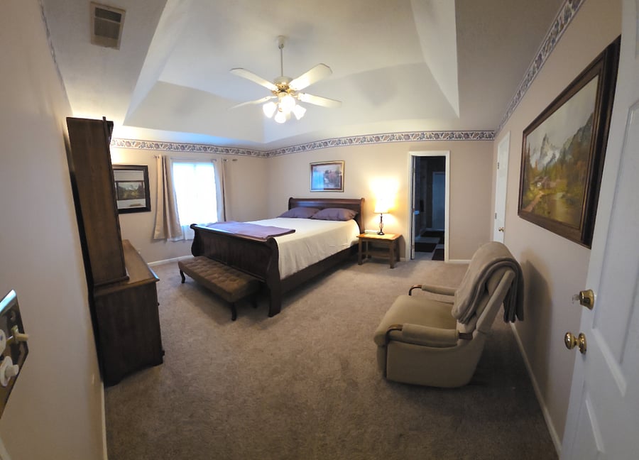 Master bedroom with dresser, mirror, bedstand/lamp and Lazy Boy recliner