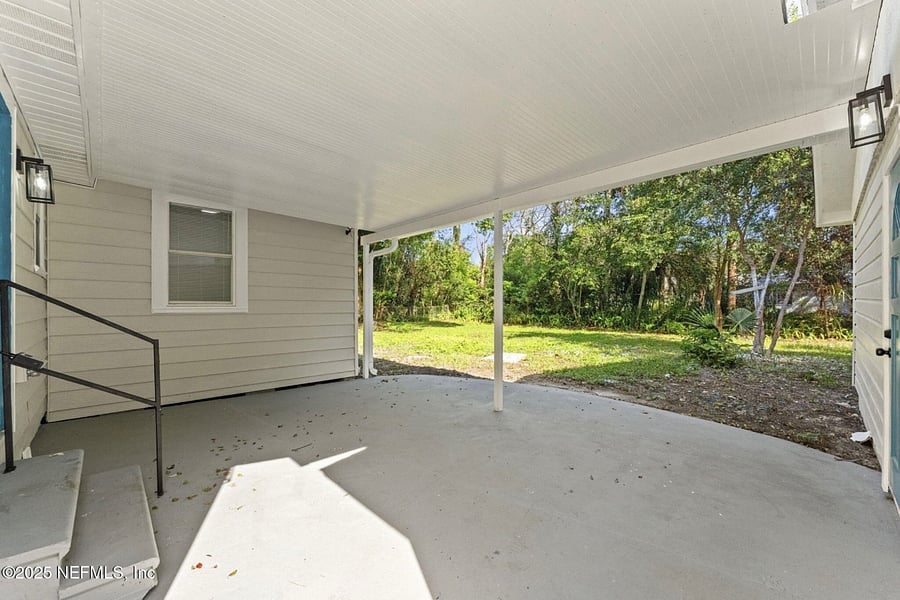 Covered back patio/porch.  Private entrance/exit to the suite located under the covered patio. Washer and dryer are in the garage to the right (not pictured).  Also not pictured is the added table and chairs under the covered patio. 