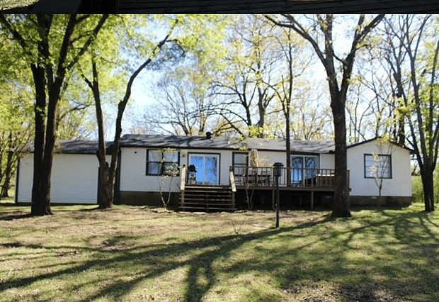 view of backside of house from bank of lake