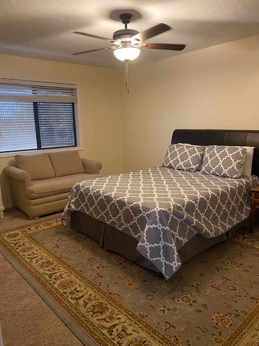 Bedroom 2 extra large studio feel. Queen size bed, a loveseat, large closet, ceiling fan, and smart tv.