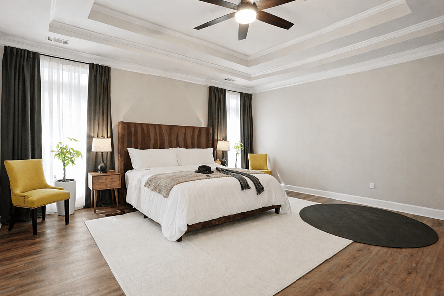 Spacious primary suite on the main level featuring natural light and a calm, comfortable layout.