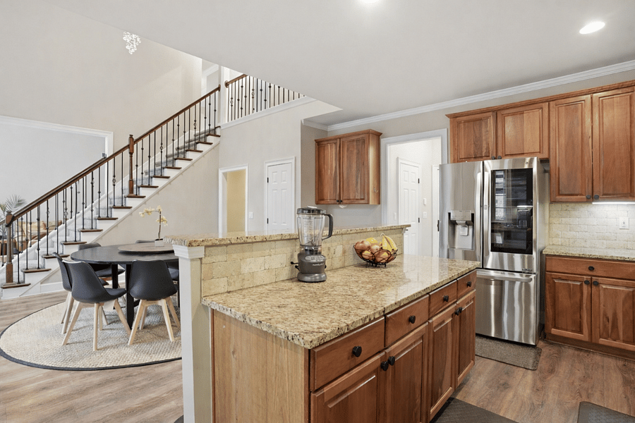 Fully equipped kitchen with modern appliances and ample space for cooking and gathering.