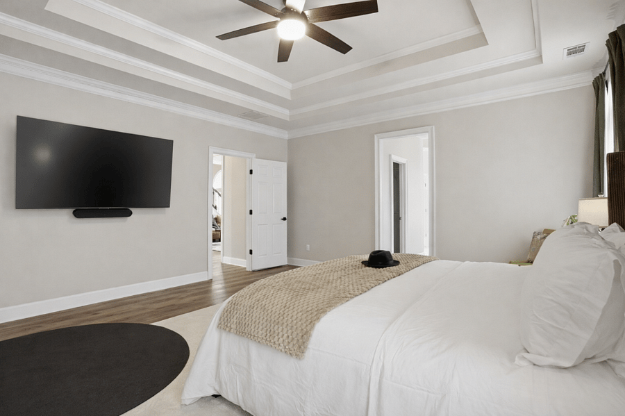 Alternate view of the primary suite highlighting its spacious layout and natural light