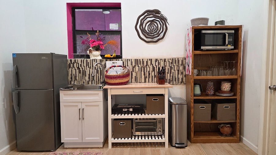 Kitchenette with sink, fridge, microwave, convection oven and tabletop stove