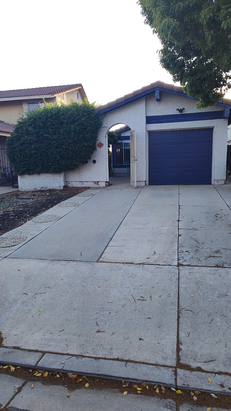 Space to left of doorway, dirt area is being converted to a designated parking space. Coming soon! 