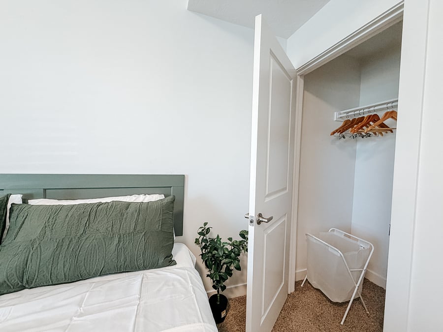 Primary Master Bedroom with Full Bathroom

Spacious first-floor master bedroom featuring a comfortable king bed with green bedding, large window with blackout curtains for better sleep, wall-mounted TV, and direct access to a private full bathroom.