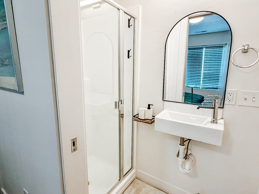 Primary Master Bedroom with Full Bathroom

Spacious first-floor master bedroom featuring a comfortable king bed with green bedding, large window with blackout curtains for better sleep, wall-mounted TV, and direct access to a private full bathroom.