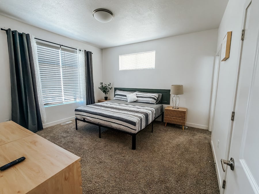 Primary Master Bedroom with Full Bathroom

Spacious 2nd-floor master bedroom featuring a comfortable king bed with green bedding, large window with blackout curtains for better sleep, wall-mounted TV, and direct access to a private full bathroom.