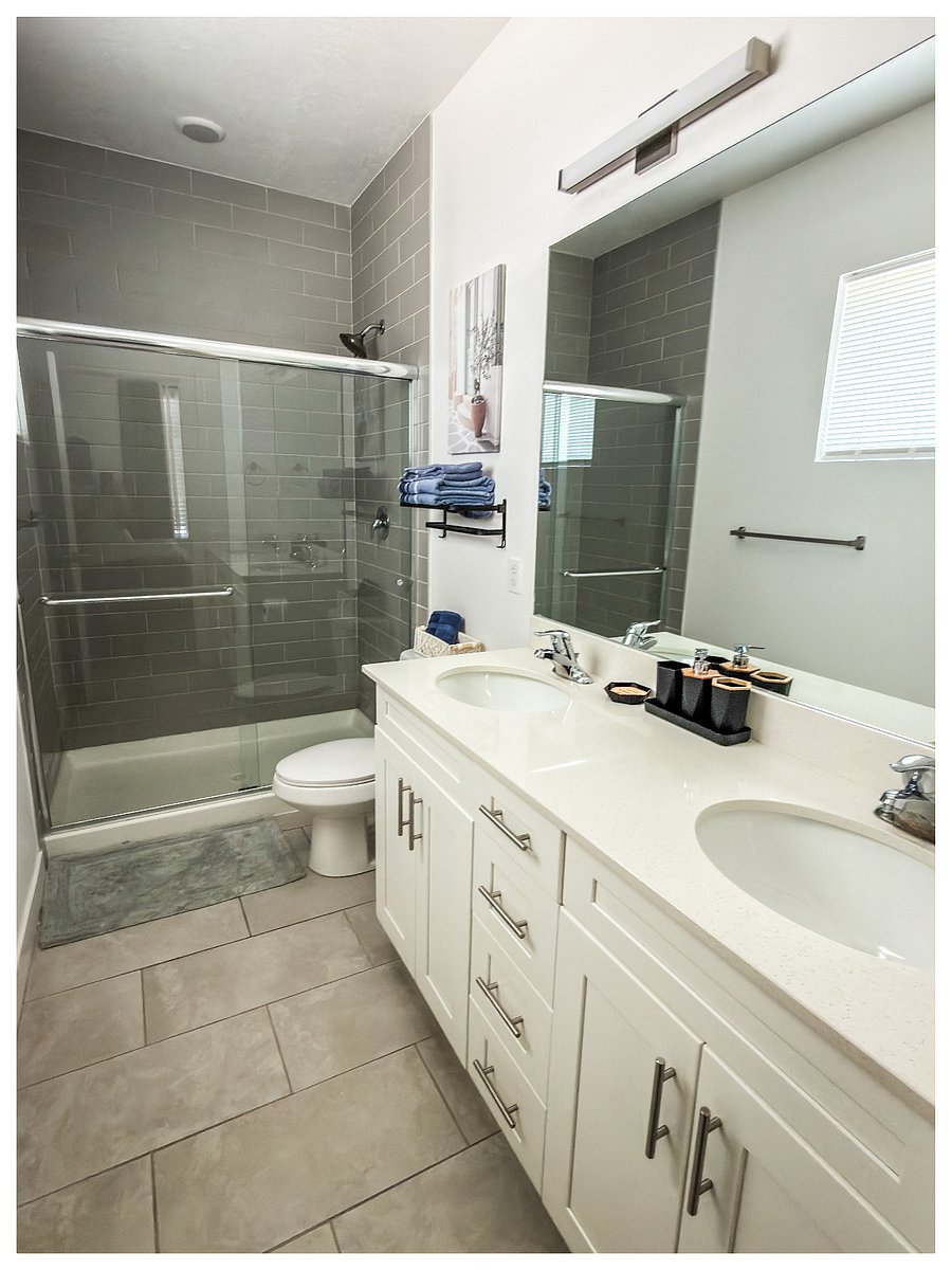 Primary Master Bedroom with Full Bathroom

Spacious 2nd-floor master bedroom featuring a comfortable king bed with green bedding, large window with blackout curtains for better sleep, wall-mounted TV, and direct access to a private full bathroom.