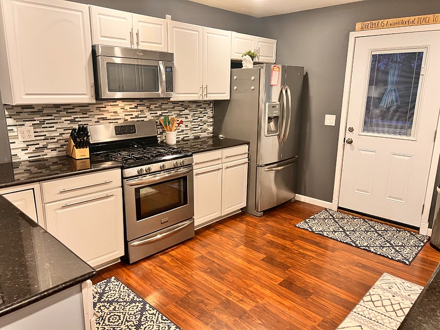 Kitchen with microwave, stove, and full sized fridge.