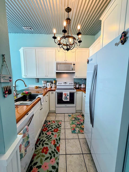 Kitchen with stove, microwave, diswasher, side-by-side refrigerator and freezer.