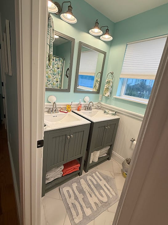 Upstairs bathroom with 2 vanities and bathtub with shower