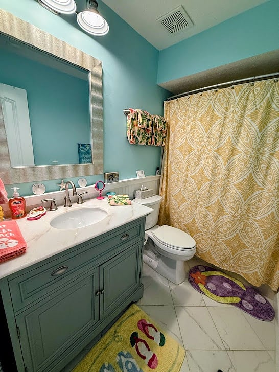 Downstairs bath with single vanity, bathtub with shower
