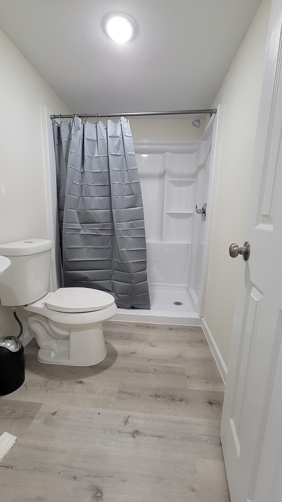 Modern full bathroom featuring a sleek vanity and updated flooring