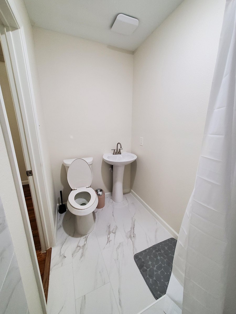 Modern full bathroom featuring a sleek vanity and updated flooring
