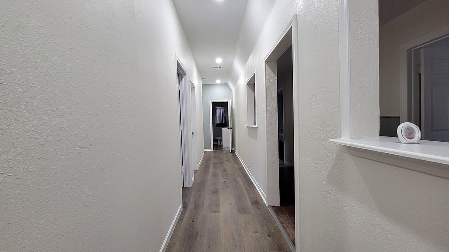 Bright and welcoming hallway -- clean, well-lit, and easy to navigate throughout the home.