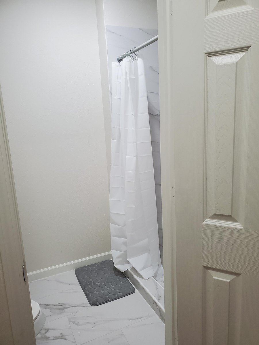 Modern full bathroom featuring a sleek vanity and updated flooring
