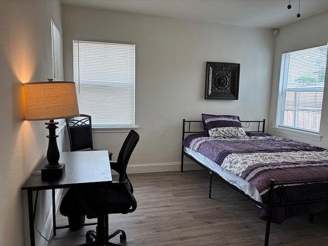 Room 2 with Queen Bed. Workspace, and clothes hanging system