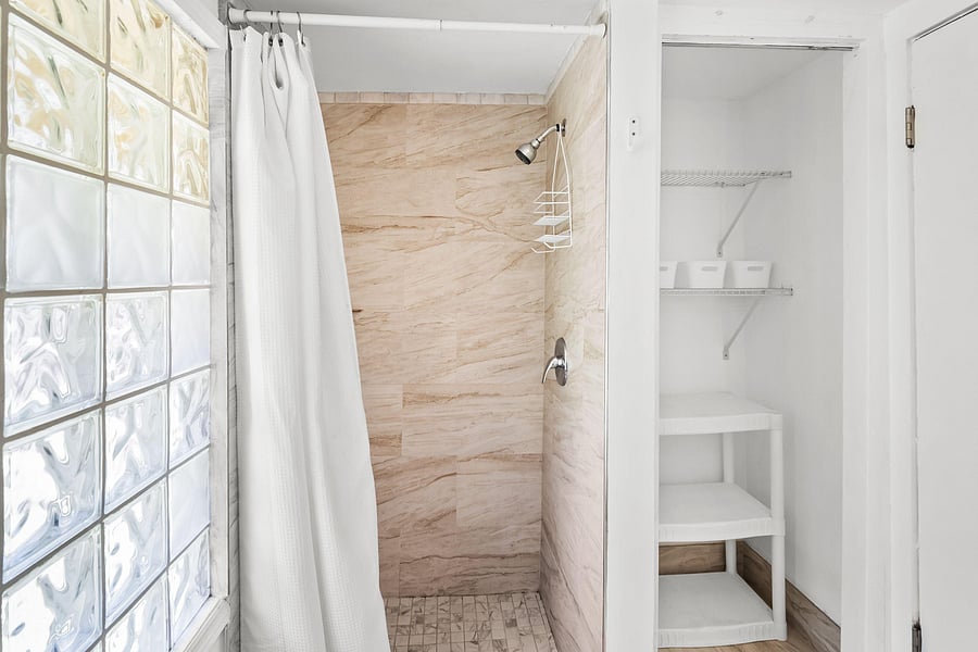 Stand up tile shower and storage closet