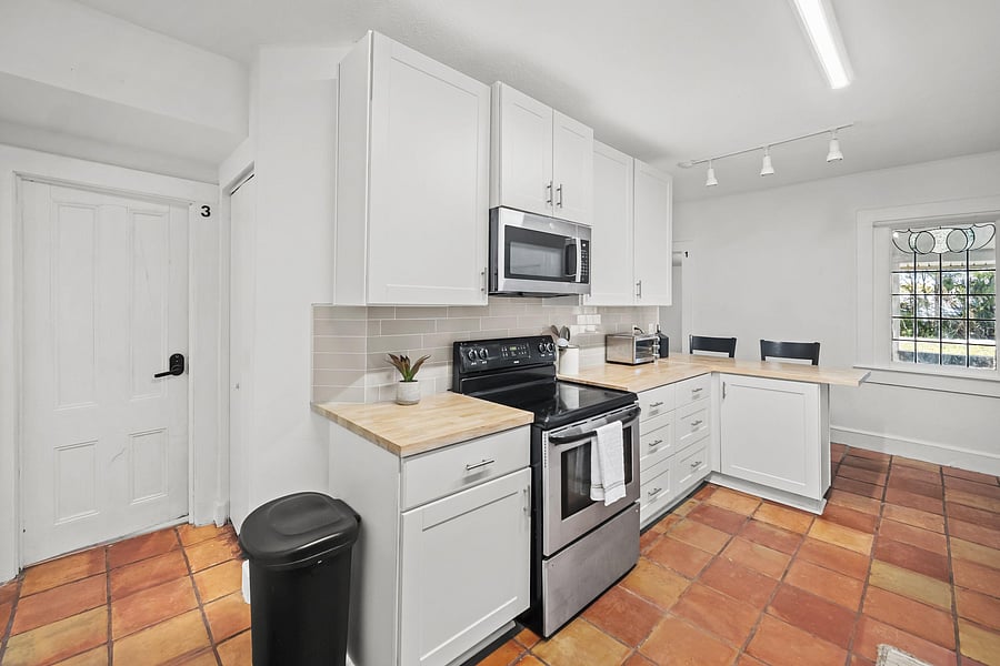 kitchen area with stove and microwave
