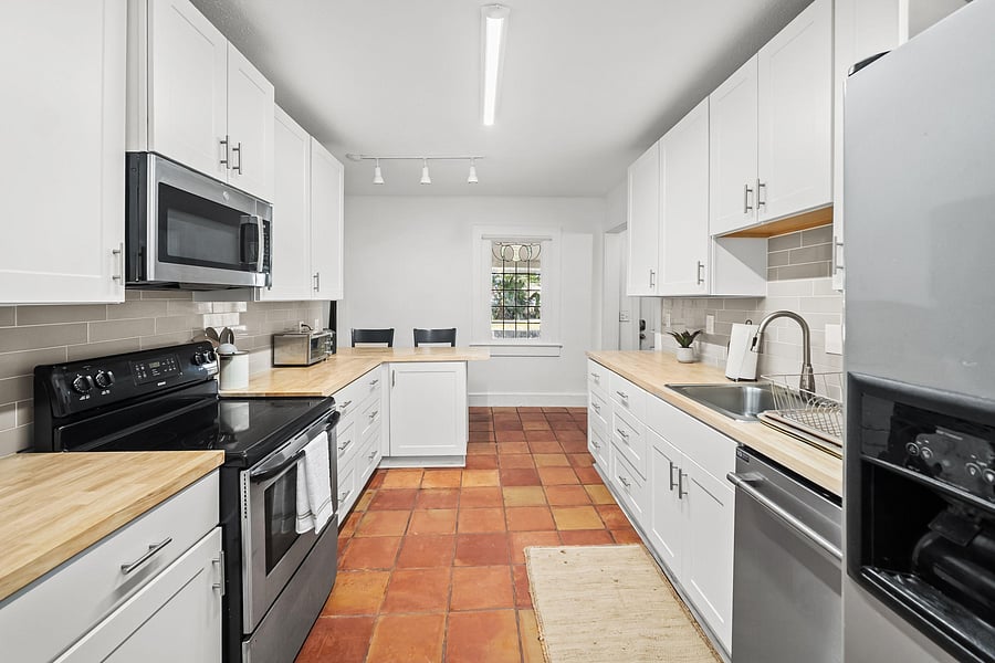 Kitchen area with oven, toaster oven and microwave