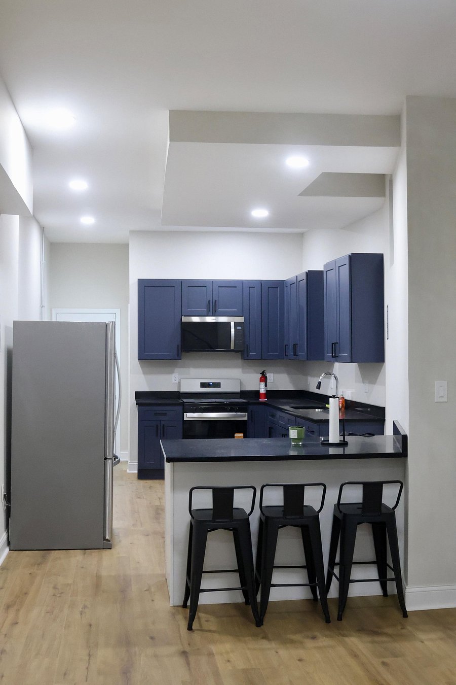 Kitchen with blue cabinets and black sparking quartz countertops
