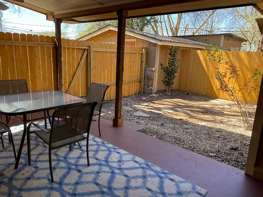 Back covered patio, which is fully fenced in.