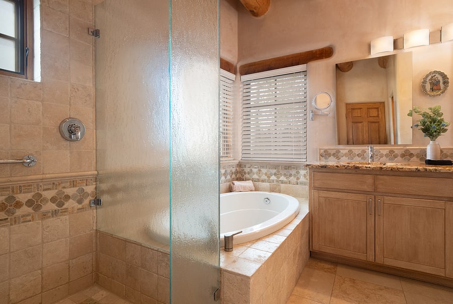 Master bathroom with double sinks, large tub, shower, toilet room and walk-in closet.