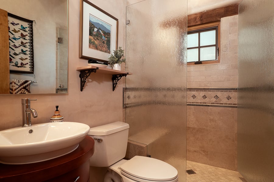 Second bathroom with walk-in shower between guest bedroom and office.