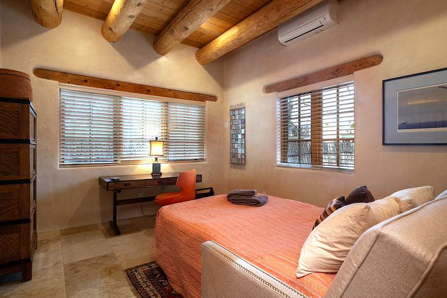 Office with sofa pulled out to queen bed.