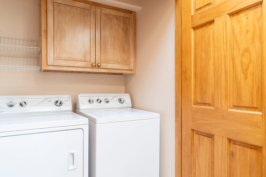 Full size washer, dryer, andstorage behind doors.