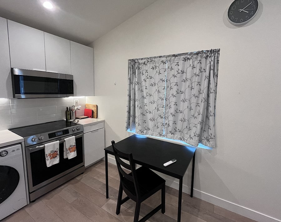 The table can easily serve as a laptop area or a place to eat or create. The catio entrance is through this window.