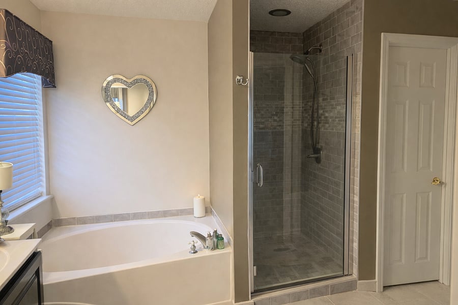 Full bathroom with soaking tub and separate glass shower.
