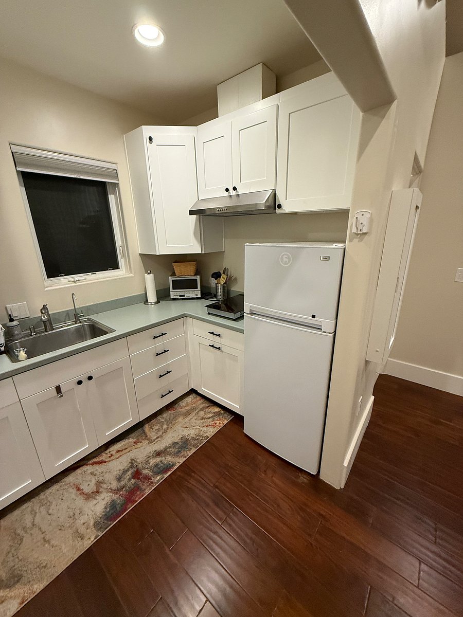 Medium sized fridge/freezer. 2 burner cook top with hood.