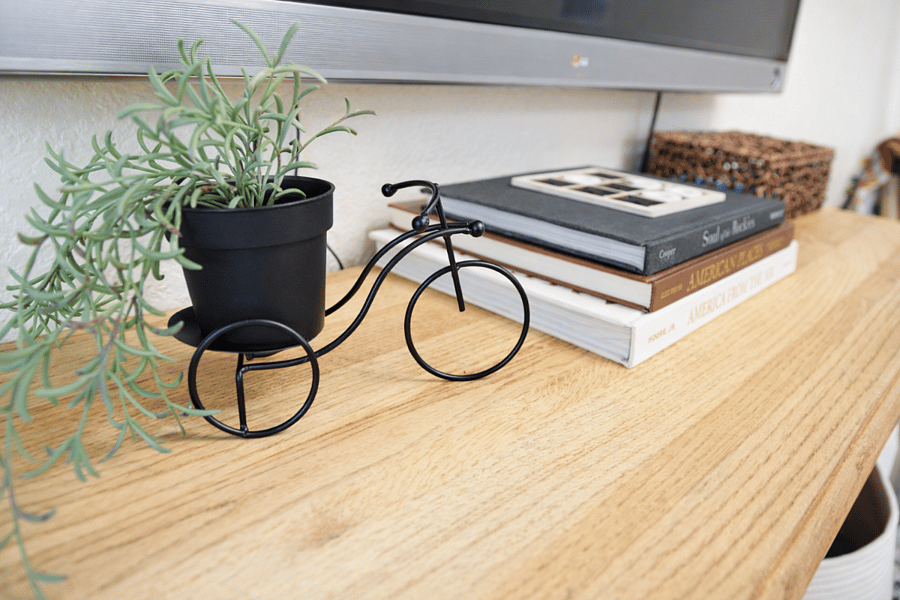 Thoughtfully styled console with warm wood accents, curated dcor, and a clean, modern look throughout.