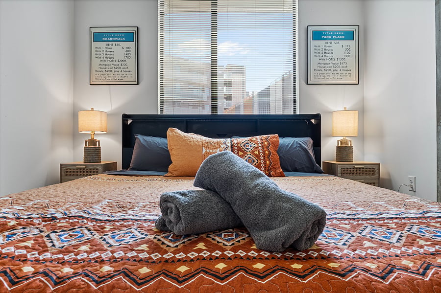 Rest easy in the bedroom featuring a King-size bed outfitted with premium linens and plush pillows. Designed for ultimate comfort, this tranquil space offers the perfect retreat for a restful night's sleep after a busy day in the city.