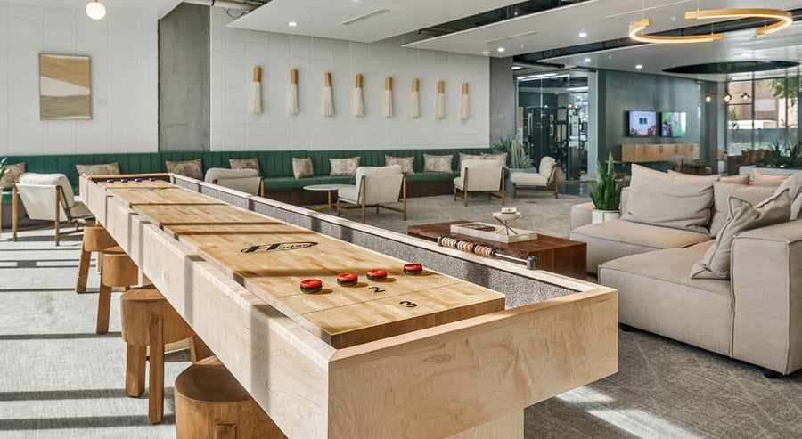 Kick back in the Entertainment Lounge, featuring a classic shuffleboard table and a dedicated card table area. Whether you're hosting a friendly game night or looking to sharpen your skills, this social space is perfect for unwinding with fellow residents.