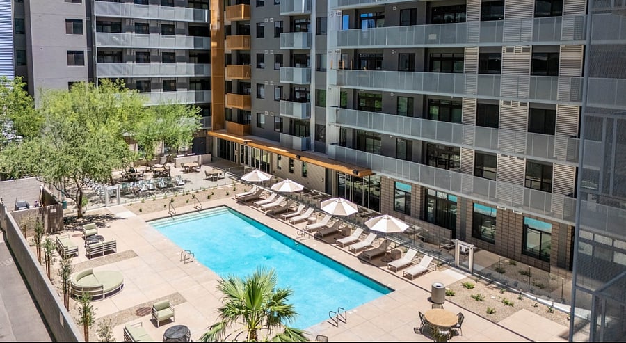 Escape to the Second Resort-Style Pool, a tranquil retreat featuring a steaming hot tub and cozy hammocks for ultimate relaxation. This expansive lounge area also includes premium BBQ grills, offering the perfect setting for poolside dining and laid-back desert afternoons.