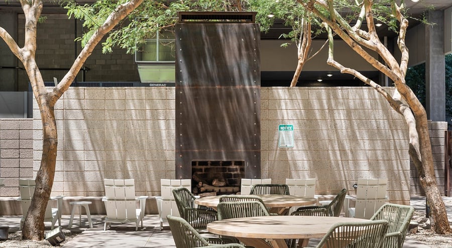 Unwind at the cozy outdoor lounge, featuring a modern fire pit and comfortable seating perfect for cool desert evenings under the stars.