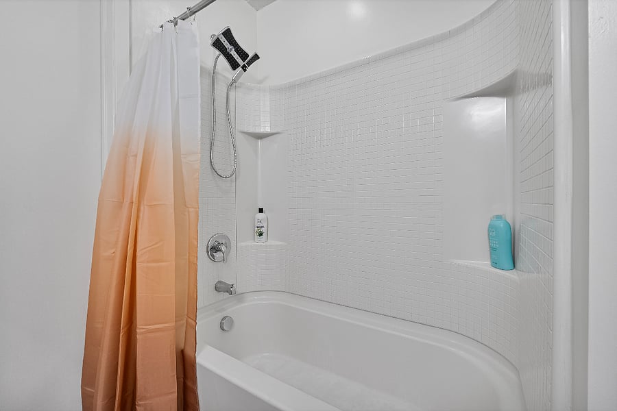 Modern bathroom featuring a soaking tub and a walk-in shower equipped with a premium rainfall showerhead.