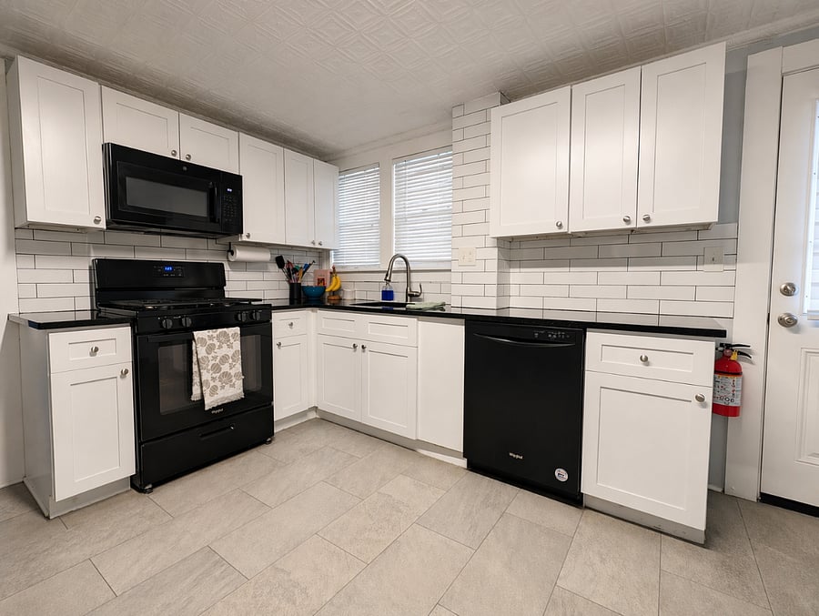 Modern kitchen equipped w/ fridge, stove, microwave, dishwasher, coffee maker, chopper, and all necessary kitchenware