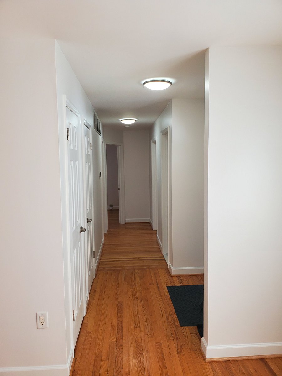 Hallway. Coat closet and linen closet on the left. Front door on the right followed by the full bath.