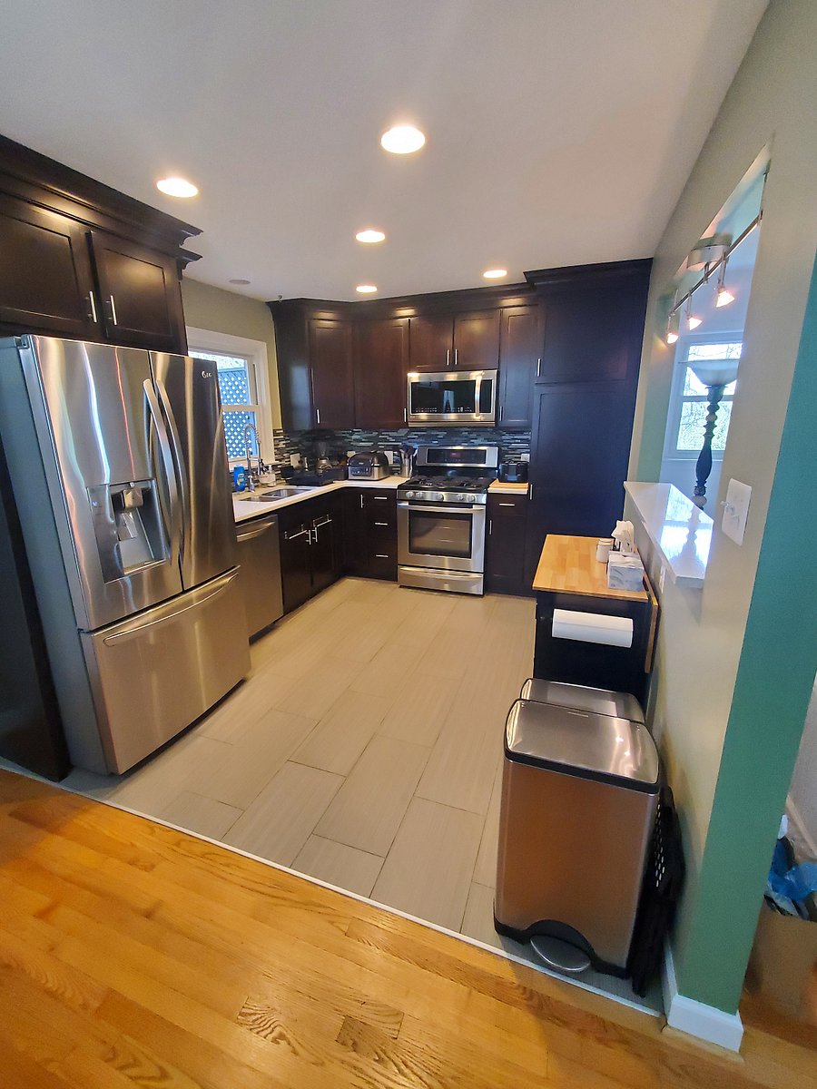 Kitchen with stainless steal appliances, refrigerator dispenses water and ice cubes. Gas stove, microwave, blender, coffee maker, and Ninja Foodi 6-in-1 Indoor Grill with Air Fry, Roast EG201 Black/Silver: Smokeless, Cool Touch, Digital Display, Dishwasher-Safe.