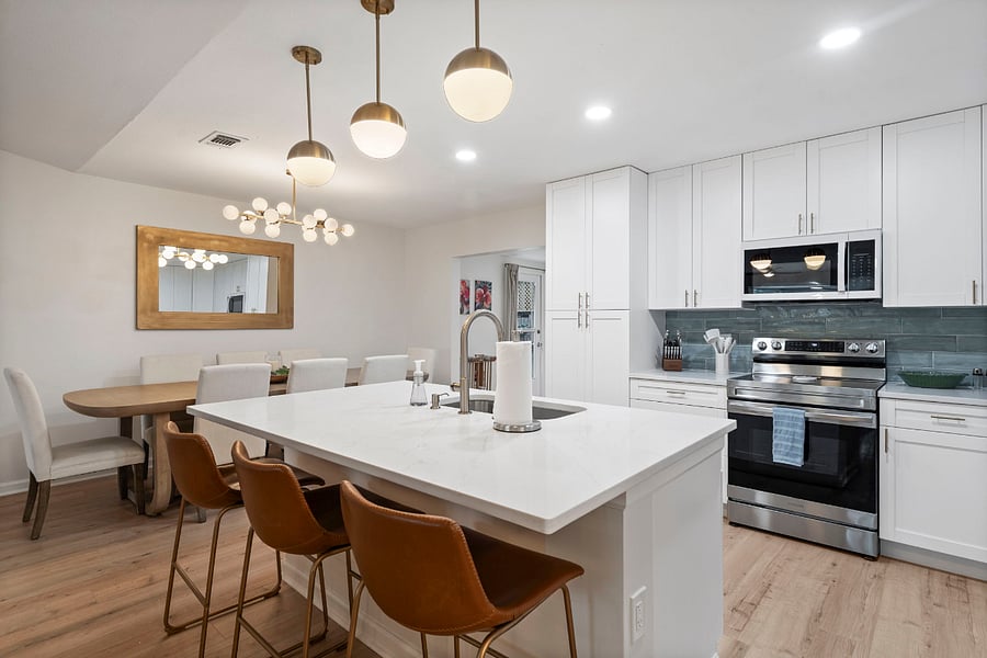 The kitchen, family room and dining area have a beautiful, open floor plan, allowing for a great space to relax and live in. The dining table is sizable and can accommodate 10 people.