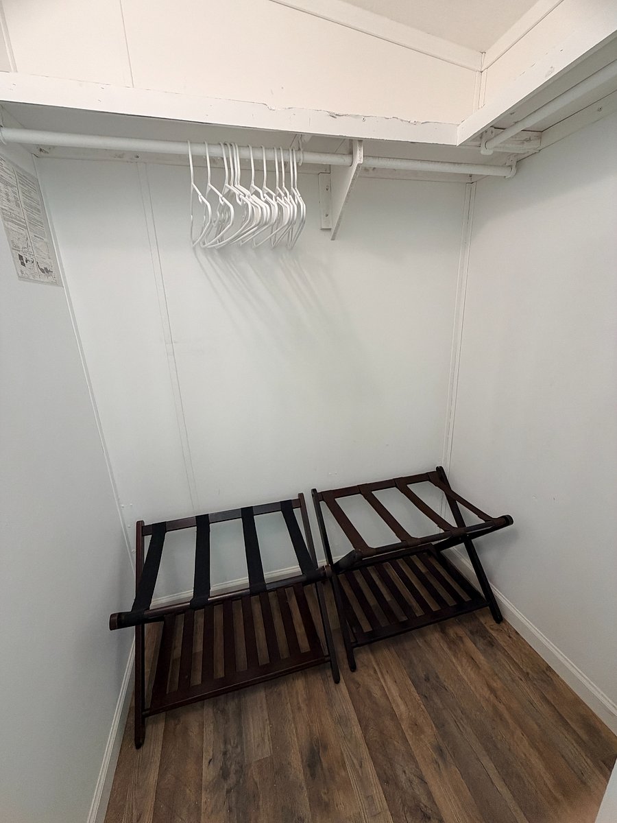 The master bedroom closet has two luggage racks.