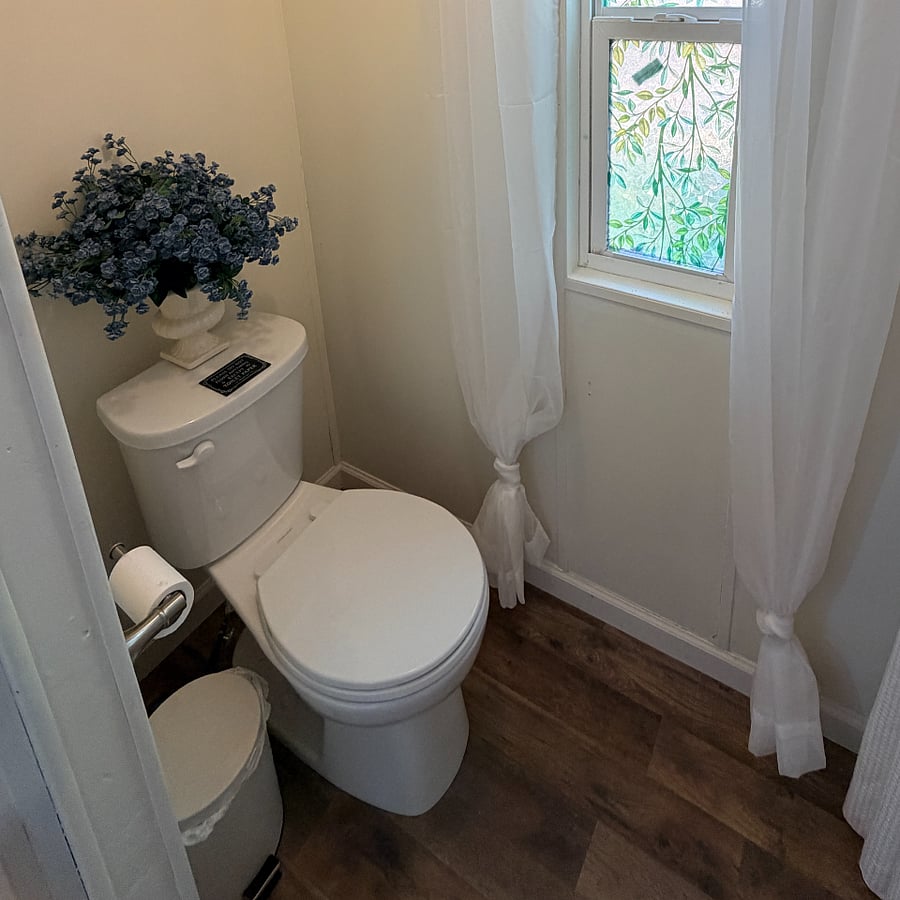 Master bathroom includes privacy film on windows plus drapery.